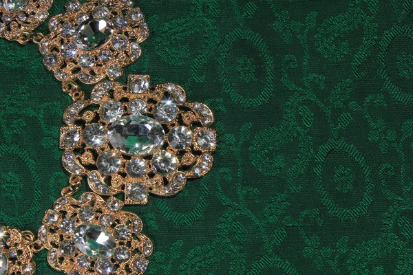 luxury jewelry in the Baroque style on a green background. Vintage, retro style.
