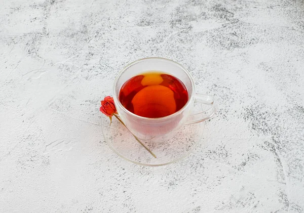 Чашка чая и розы на сером фоне — стоковое фото
