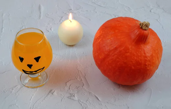 Хеллоуїн композиція з напоєм, апельсиновий коктейль, гарбуз, свічка — стокове фото