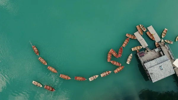 Top view wooden stilt house with rowing boats on a lake or a river.