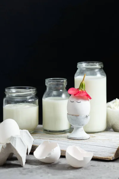 Fresh dairy and fermented milk products. Eggs On a black background.