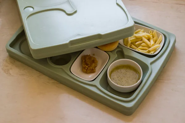 Hard plastic hospital food tray with foods.Top view