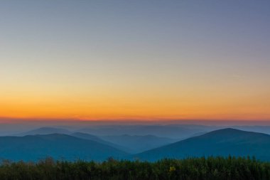 Bir dağ geçidindeki ilk ya da son güneş ışınları. Doğada sabah akşam. Dağ tepelerinde renkli günbatımı ve gün doğumu. Karpatlar yazın ve sonbaharda.