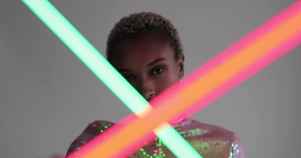 High fashion model posing with neon tubes in studio — Stock Video