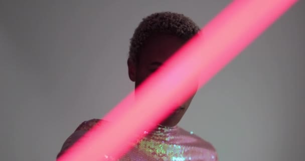 High fashion model posing with neon tubes in studio — Stock Video