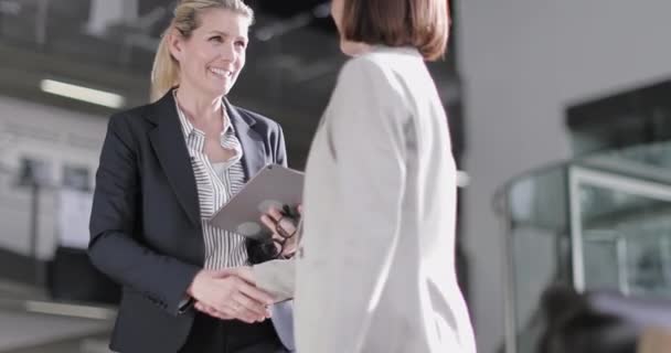 Senior female business executives in a meeting looking at a digital tablet — Stock Video