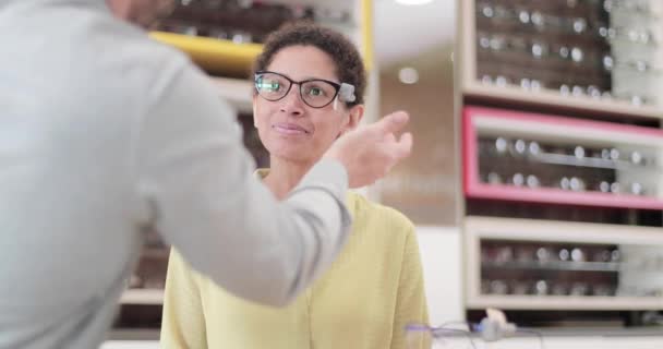 Optician suggesting frames to customer — Stock Video
