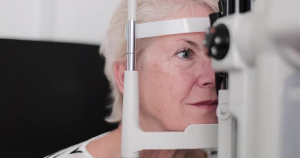 Closeup of senior woman having an eye test — Stock Video