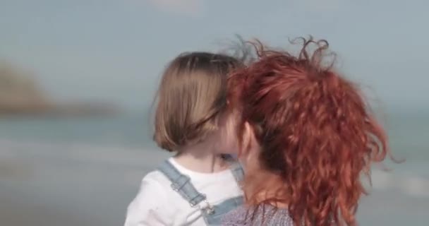 Mother and child embracing on beach — Stock Video