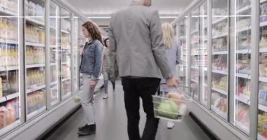 Satış asistanı markette müşteriye yardım ediyor.