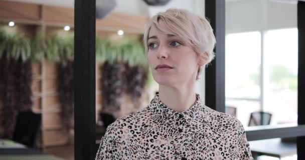 Portrait of a female freelancer in a coworking space — ストック動画