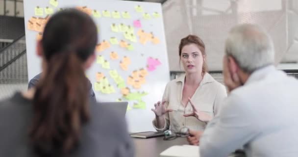 Jong volwassen vrouw spreken in een brainstorm vergadering — Stockvideo