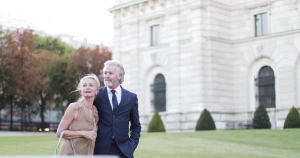 Glamorous senior couple walking towards opera on luxury holiday — Stock Video