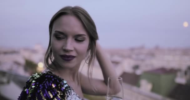 Belle femme caucasienne en robe de cocktail sur le toit en jouant avec les cheveux — Video