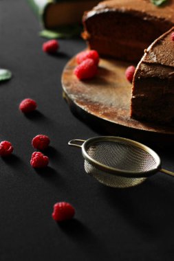 Ele geçirin. Ahududulu çikolatalı pasta. Koyu arkaplanda pasta
