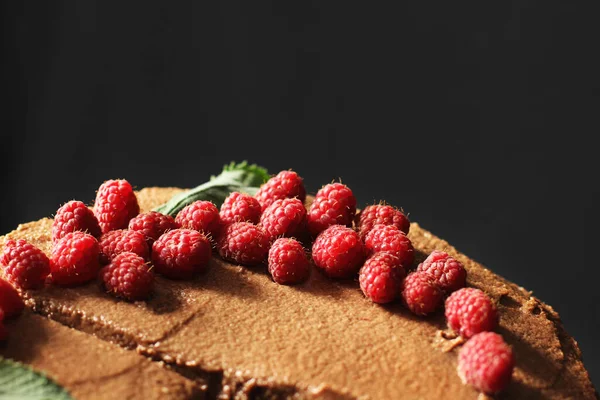 Prague cake. Chocolate cake with raspberries. Cake on a dark background.