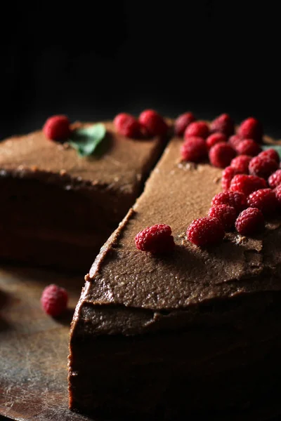 Prague cake. Chocolate cake with raspberries. Cake on a dark background.