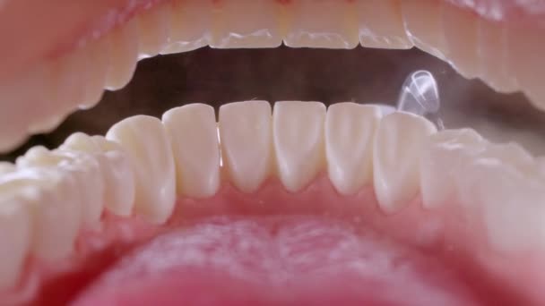 Vatten tandtråd rengöring tänder på svart — Stockvideo