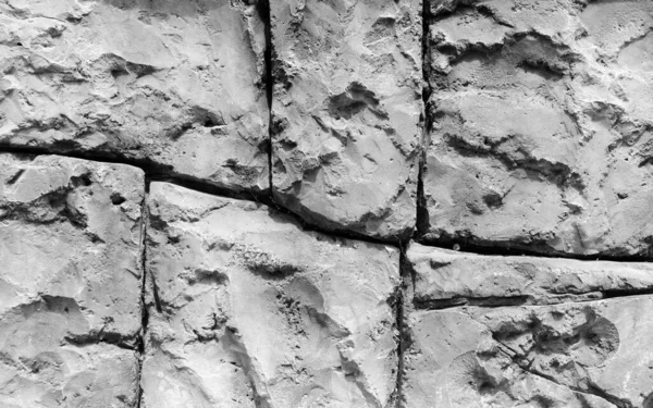 Gothic background with brick wall of stones. Cracks and scratches close up