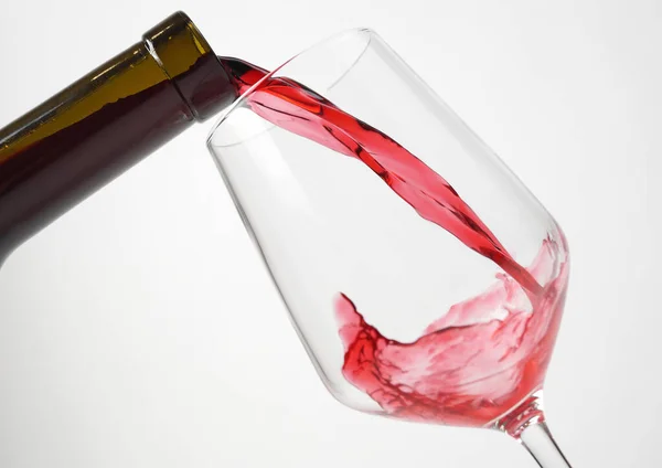 A bottle of wine and splash in a glass Stock Photo