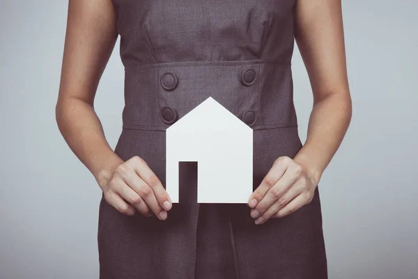 Vintage tone of picture of woman holding paper house