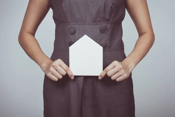 Vintage tone of picture of woman holding paper house