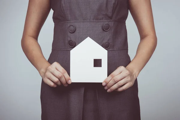 Vintage tone of picture of woman holding paper house