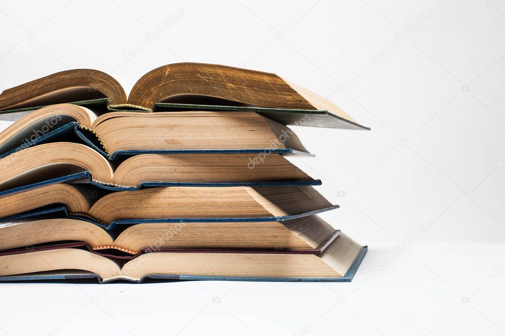 Composition with stack of books on white background