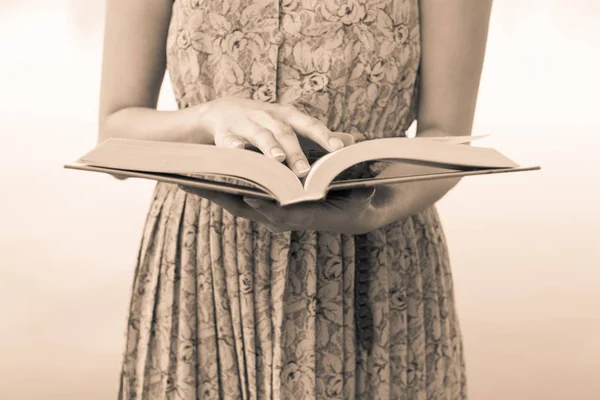 Young woman reading bible in natural park