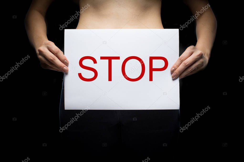 A woman holding a conceptual stop sign