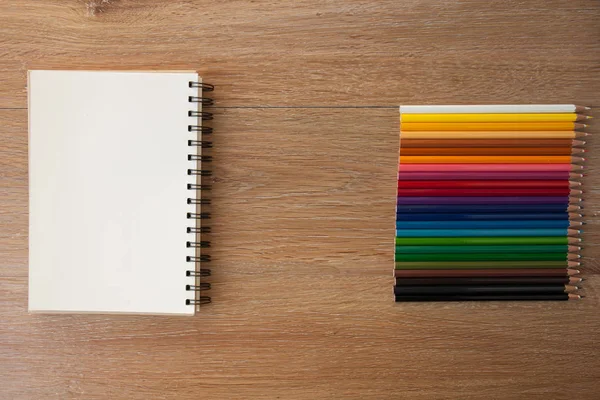 Barevné tužky s notebookem — Stock fotografie