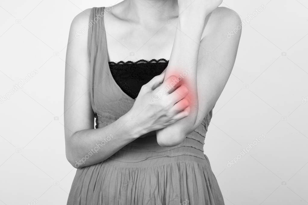 Woman scratching her elbow.