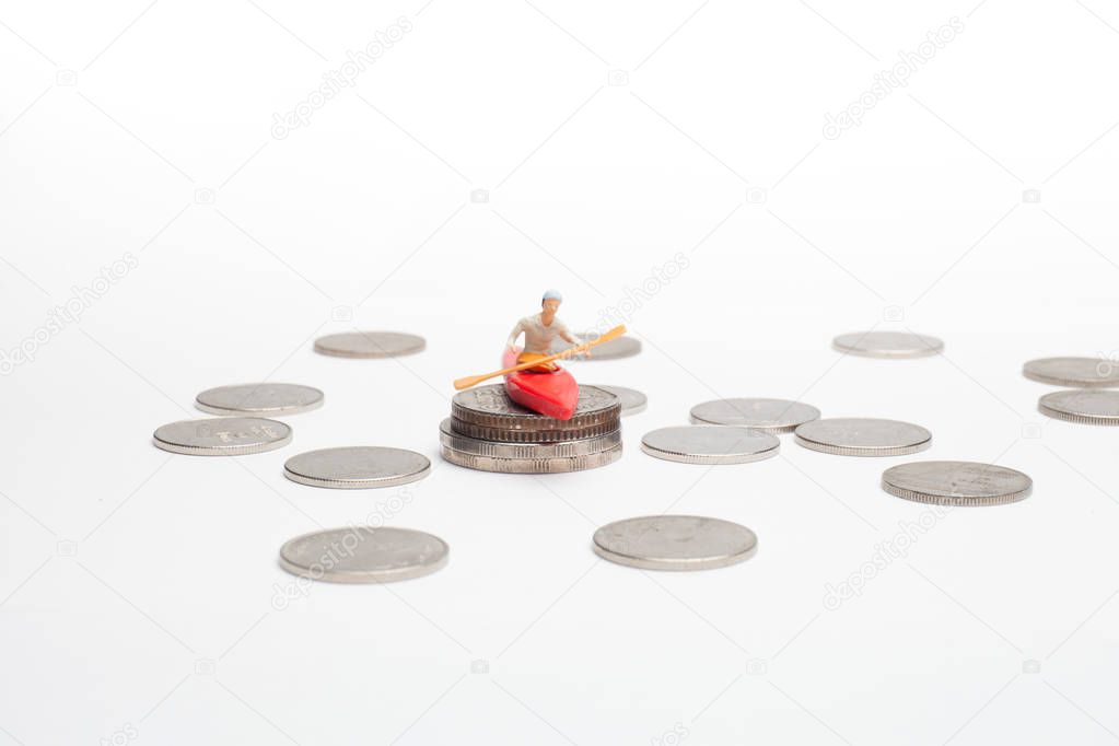 a man is on Kayak above the coins