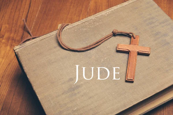 Vintage tone of wooden Christian cross necklace on holy Bible with Jude — Stock Photo, Image