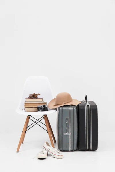 Suitcase with shoes, and cemera ready for travel — Stock Photo, Image