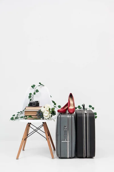 Suitcase with shoes, and flower ready for travel — Stock Photo, Image