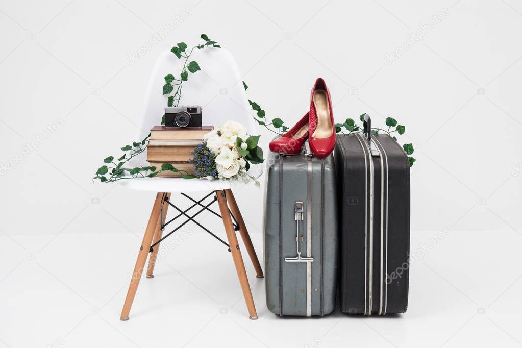 suitcase with shoes, and flower ready for travel 