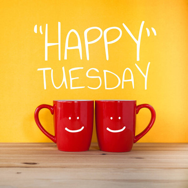 "Happy Tuesday" word two cups of coffee and stand together 