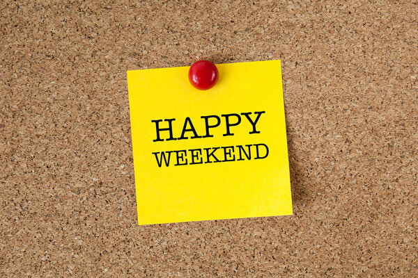 Happy weekend word with yellow reminder sticky note on cork board