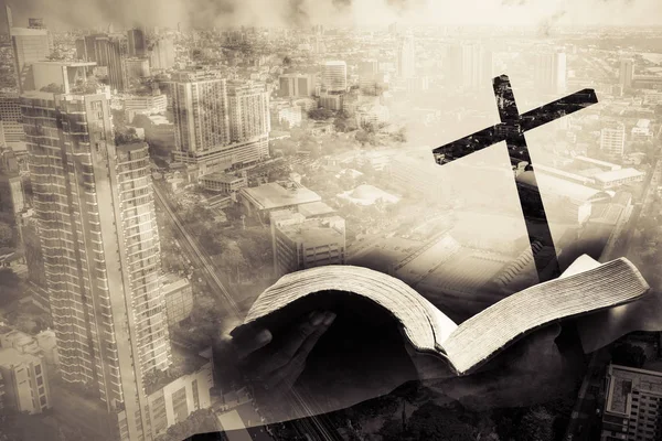 Mixed media of cross and city and hand hold bible — Stock Photo, Image