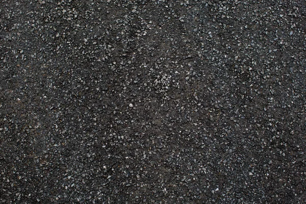 Μια σκούρα υφή δρόμου χαλίκι — Φωτογραφία Αρχείου