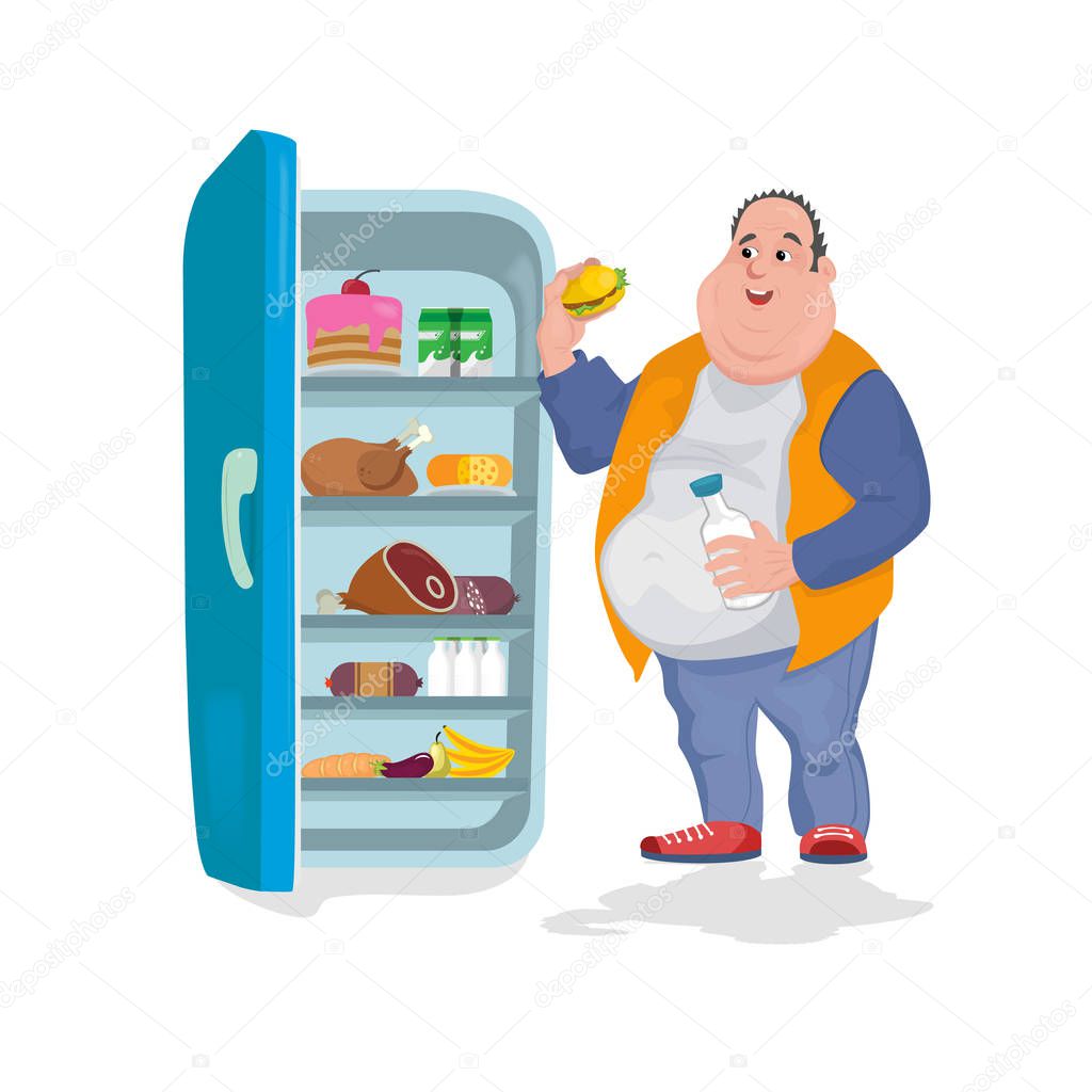 The fat man eats a hamburger in an open refrigerator in which there are many foods