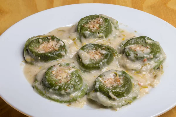 stock image green vegan ravioli with white sauce