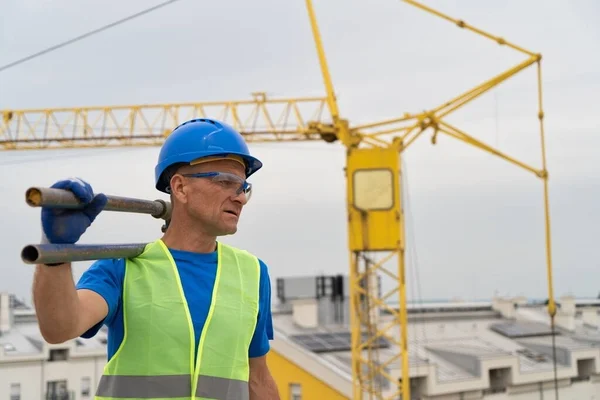 A construction worker stands on a roof on a construction site stock picture