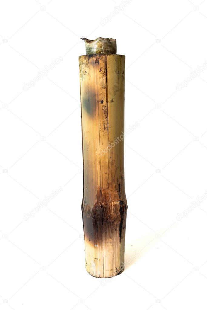 Burned sticky rice with sweet coconut milk in bamboo cylinder isolated on white background, Thai food call khao lam, Clipping Path