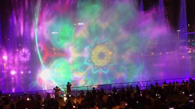 SINGAPORE -14  October 2018 : Many audiences are watching Light and water show, Songs of the sea at the front of Marina Bay Sands in Singapore clipart