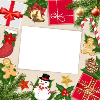 Tahtada üzerinde noel eşyası olan beyaz kağıt