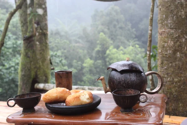 Tea set in the forest. Warm tea on the mountain