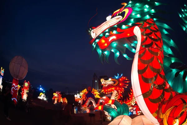 Nakornsawan ,Thailand- February 18 , 2018 : Large Chinese God and Lantern standing on the ground show and decorated at night for Chinese New Year Celebration near river in Nakornsawan Province, Middle of Thailand.