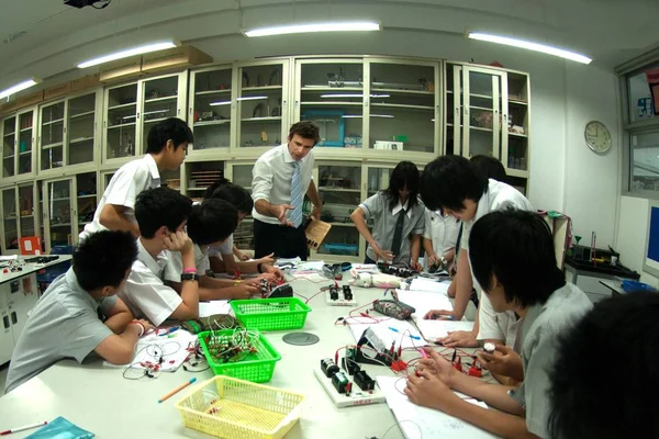 Group of Asian Elementary students are learning about electricity in classroom. — Stock Photo, Image